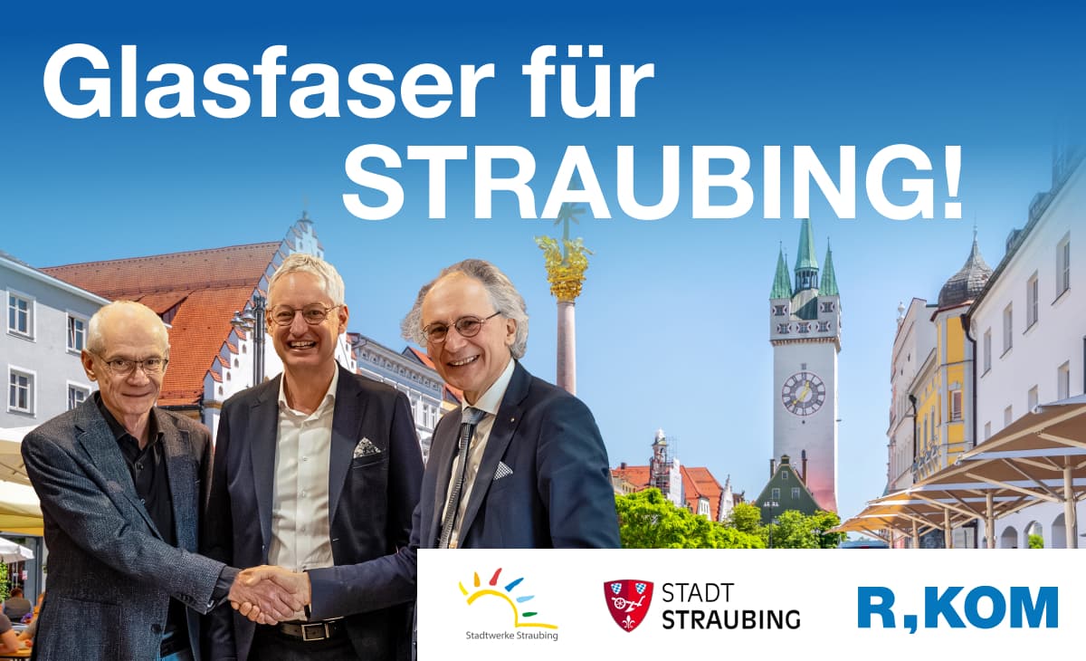 Unterzeichnung des Kooperationsvertrags für den flächendeckenden Glasfaserausbau in Straubing: Vertreter der Stadt Straubing, der Stadtwerke Straubing und der R-KOM besiegeln die Zusammenarbeit per Handschlag vor der Straubinger Stadtkulisse.